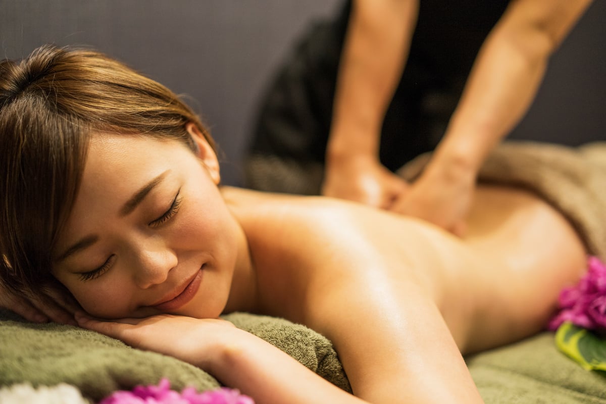 Young woman receiving oil massage