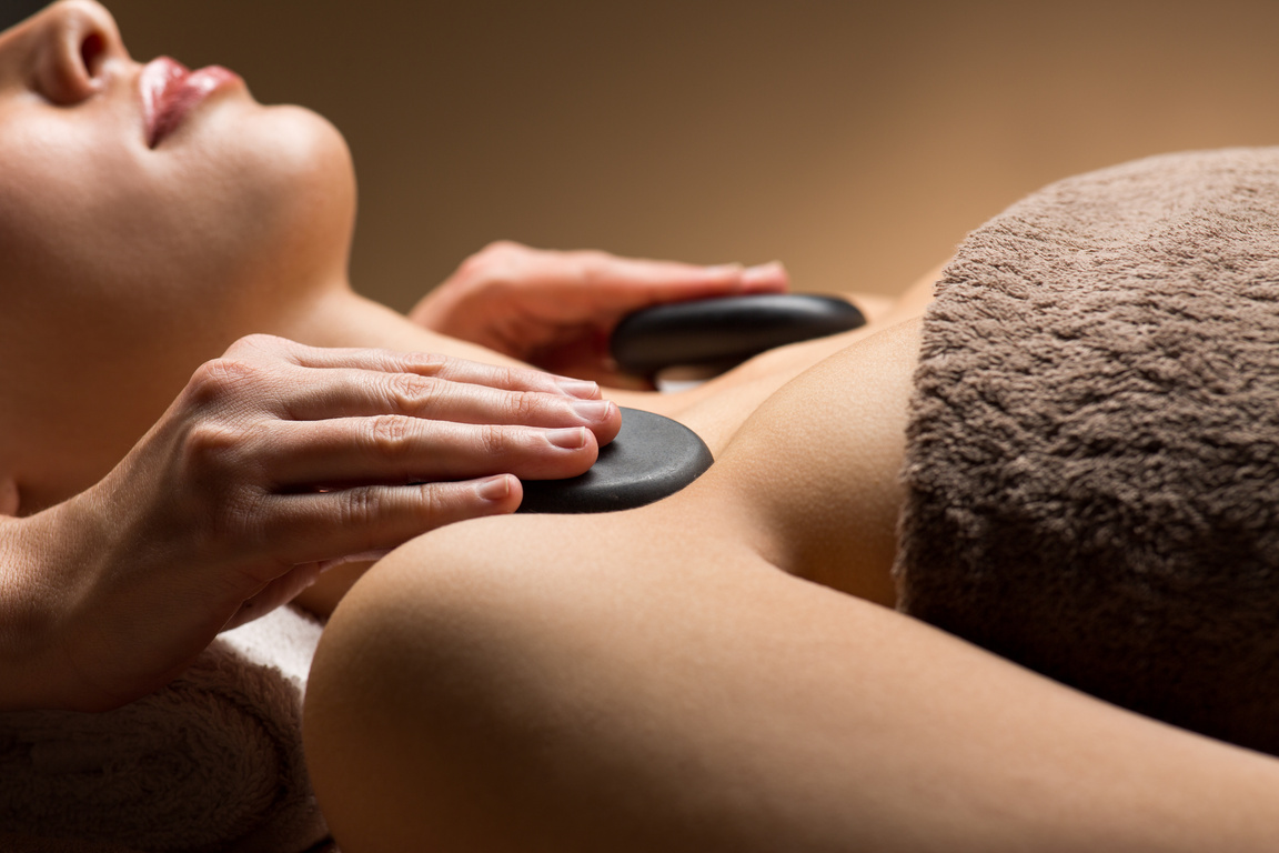 Closeup of Woman Having Hot Stone Massage at Spa